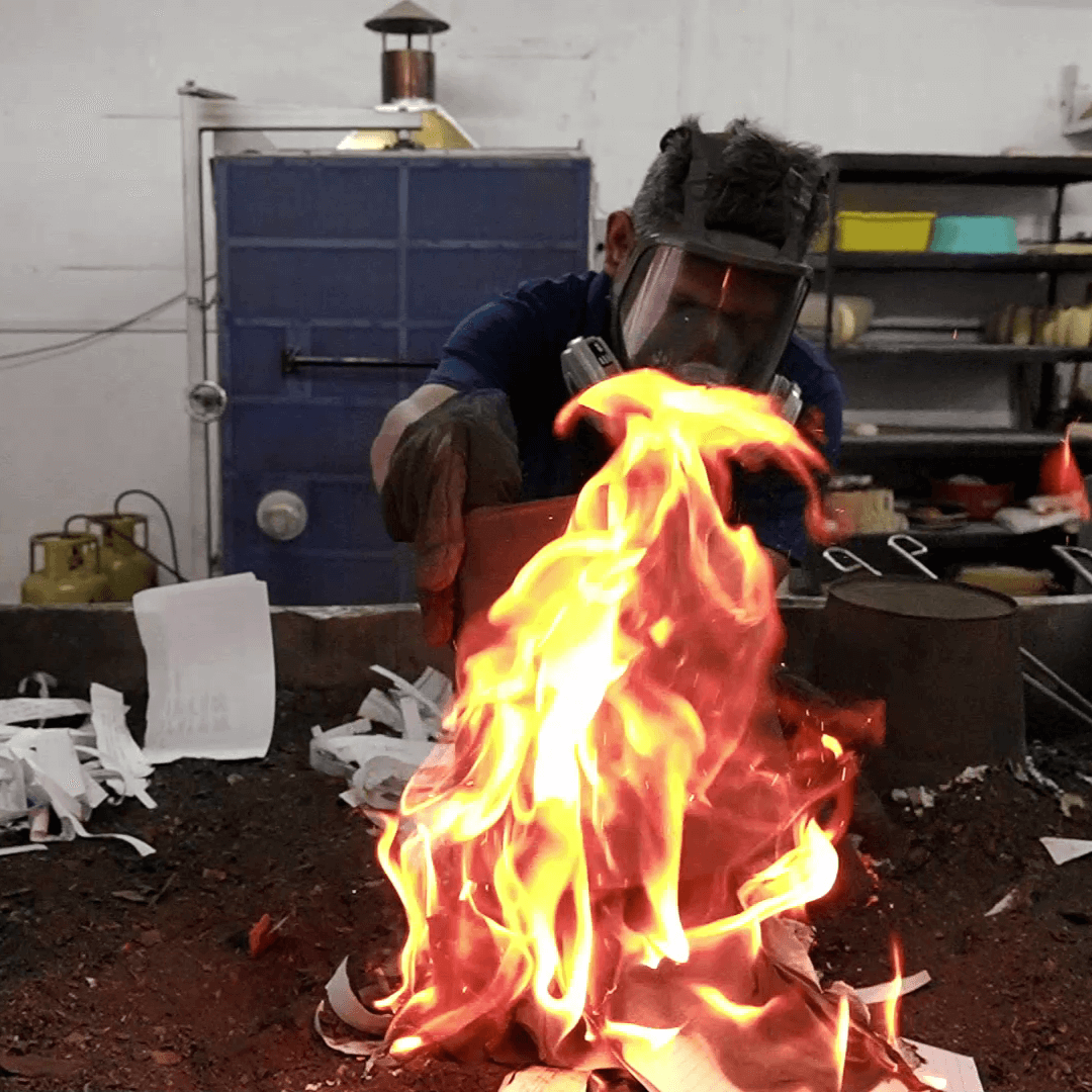Person welding with a large flame in a workshop setting